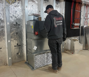 Kearns Mechanical technician checking on a unit