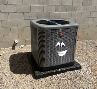 Air conditioner with a smiling cartoon face on it