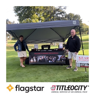 Photo of Greg and Diane Kearns in front of Kearns Mechanical tent on golf course