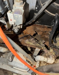 Photos of the inside of a furnace that has rusted out