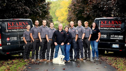 Photo of the Kearns Mechanical team standing in front of their trucks